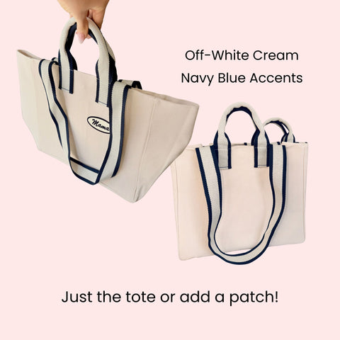 Tote bag with off-white body and navy blue accents, optional patch detail