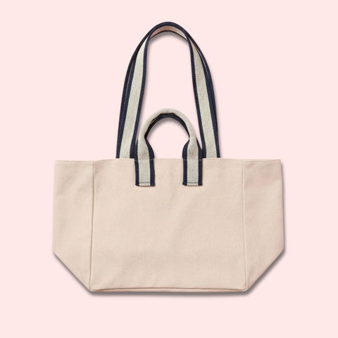 Custom canvas tote bag with name patch in off-white cotton and navy stripe handles