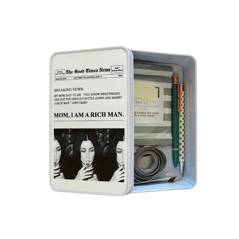Metal tin with newspaper on it for pens, office supplies