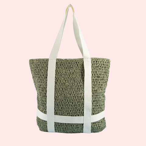 Woven tote bag with white straps on a pink background