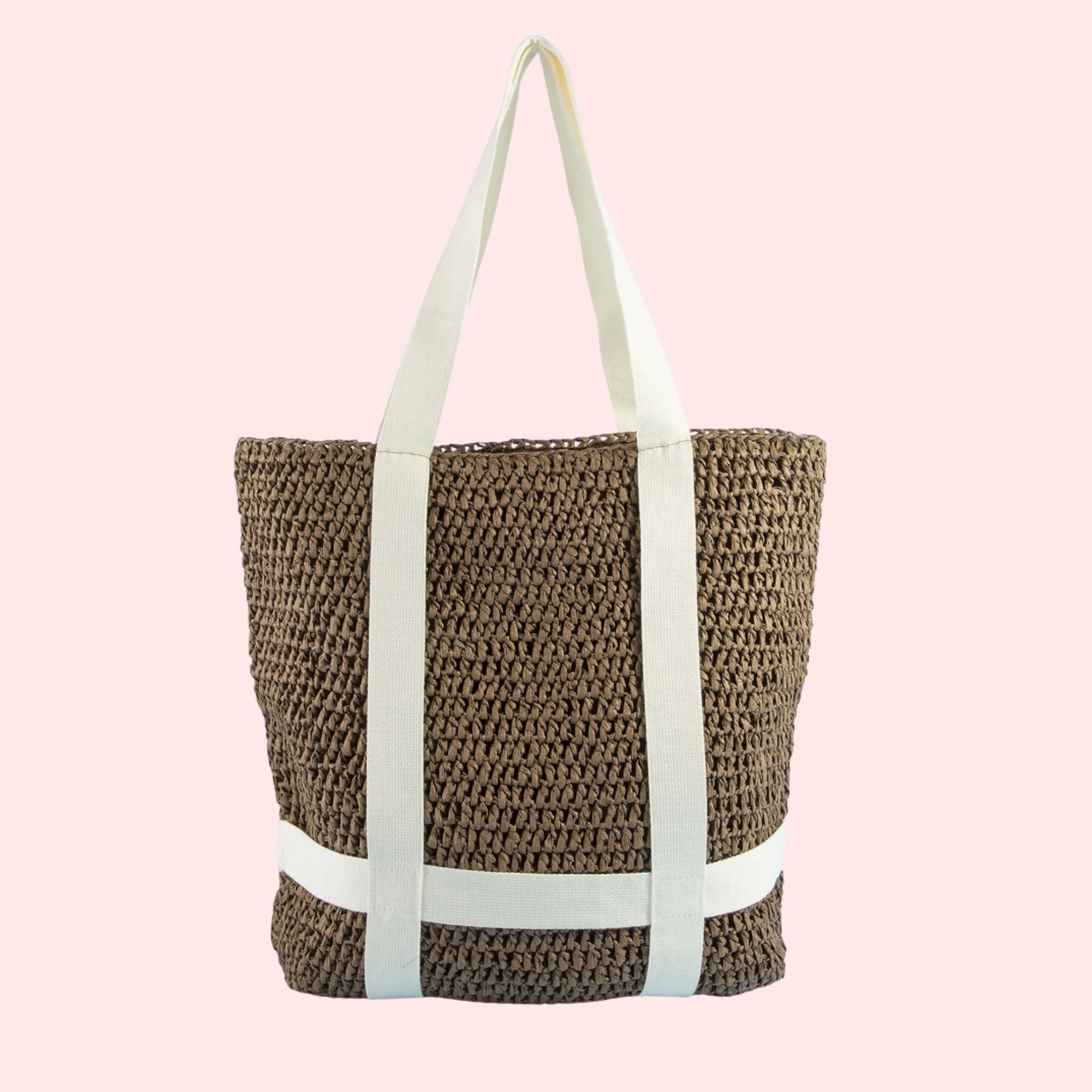 Woven tote bag with white straps on a pink background