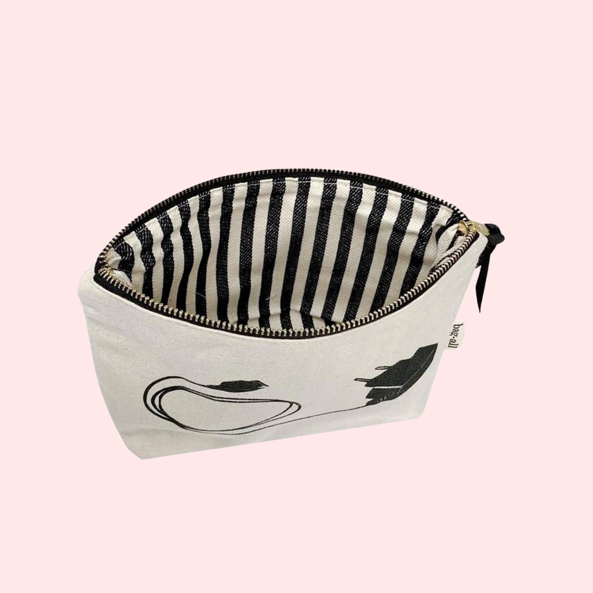 Small pouch with black and white striped interior on a pink background